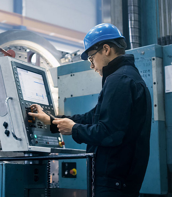 Workers use LCD touch screens on industrial equipment to adjust factory production lines