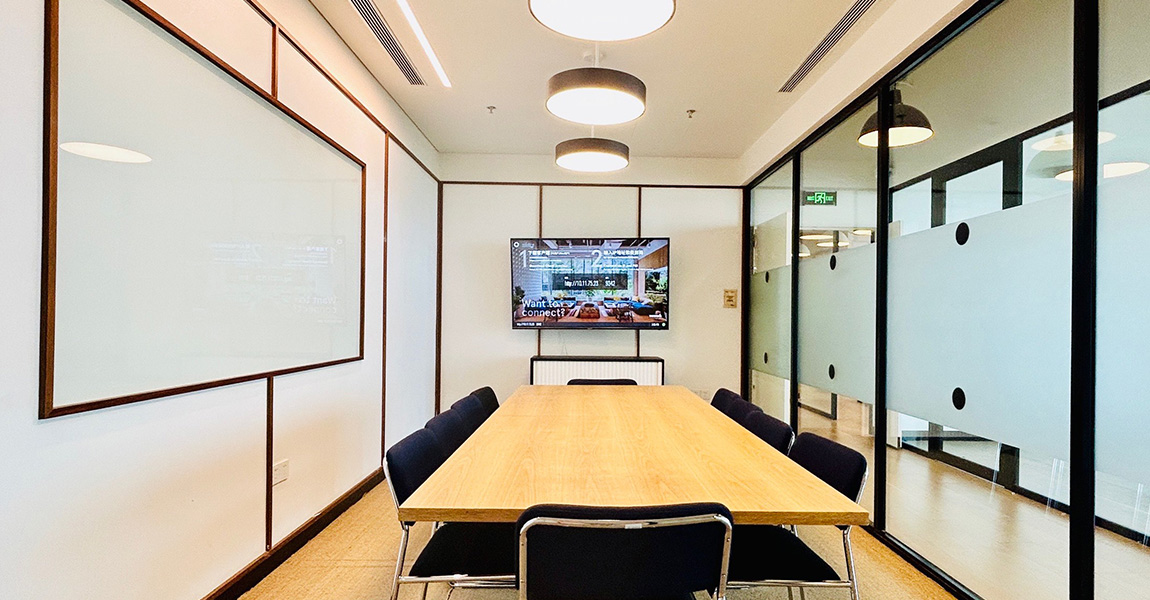 Conference room with digital display for presentations and meetings.