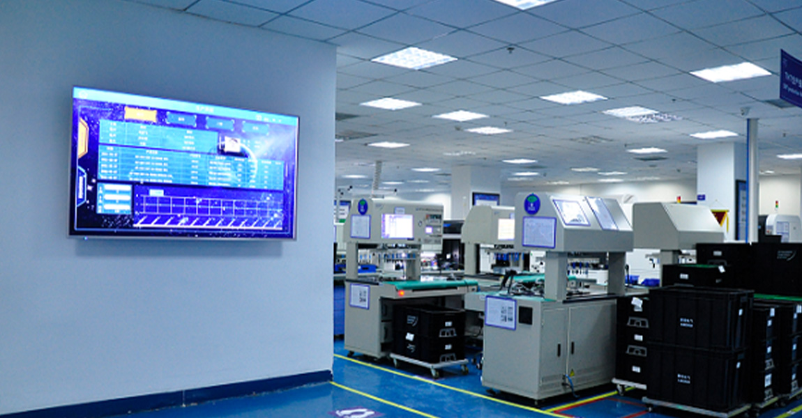 Modern industrial facility with digital monitoring display.