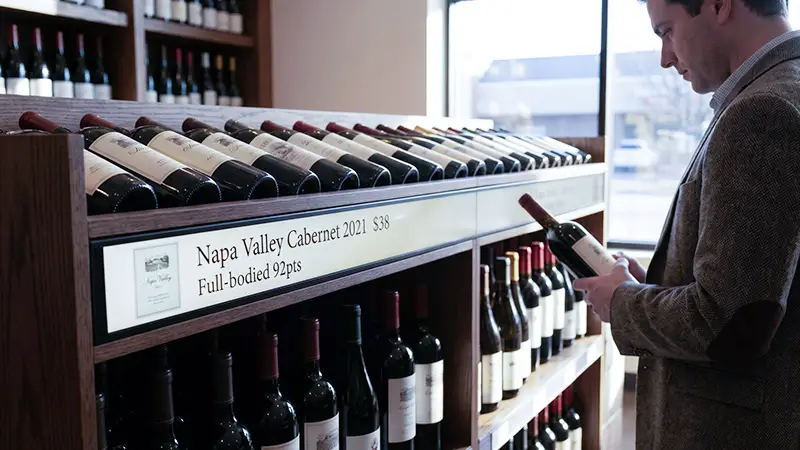 A real-world scenario of shelf-edge LCD displays being used on a wine shelf.